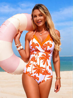 Orange palm tree print halter one-piece swimsuit with scalloped trim and a plunging neckline.