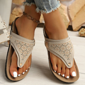 Beige hollow-out toe-post sandals with adjustable ankle strap and cork-style sole.