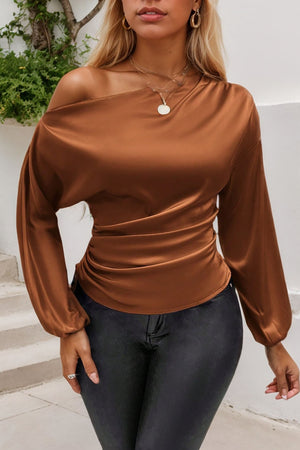 Brown satin asymmetric blouse with drape-front ruched detail and long sleeves.