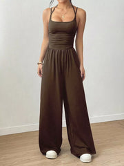 Brown ruched wide-leg jumpsuit with spaghetti straps and a comfortable fit.