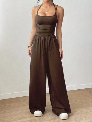 Brown ruched wide-leg jumpsuit with spaghetti straps and a comfortable fit.