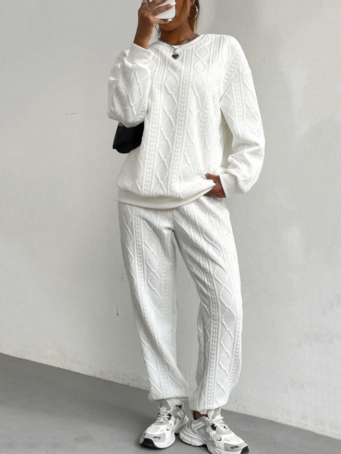 White cable knit loungewear set with crew neck sweatshirt and jogger pants.