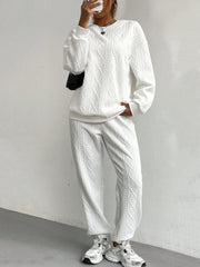 White cable knit loungewear set with crew neck sweatshirt and jogger pants.