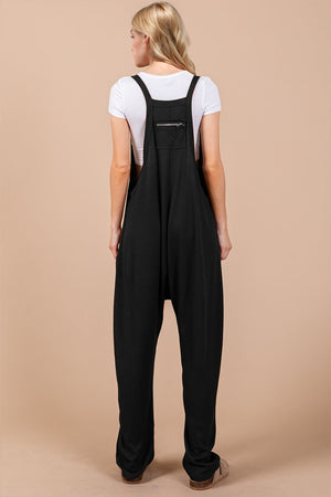 Black harem overalls with zip pocket detail and wide legs.