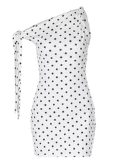 White polka dot mini dress with asymmetrical one-shoulder and bow detail