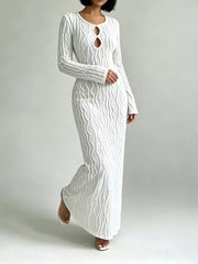 White textured long sleeve maxi dress with cutout neckline and rope-like pattern.