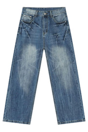 Wide-leg distressed denim jeans in vintage wash medium blue with faded details.