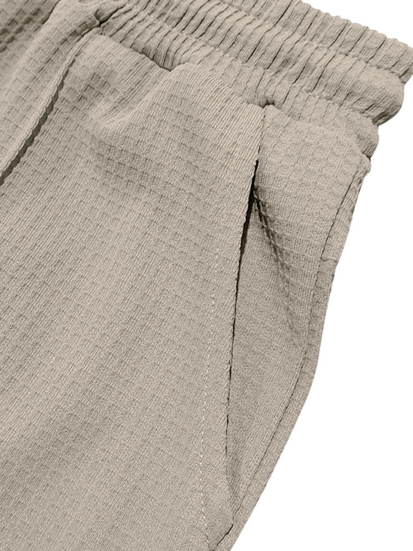 Textured drawstring sweatpants in khaki with a side pocket detail.