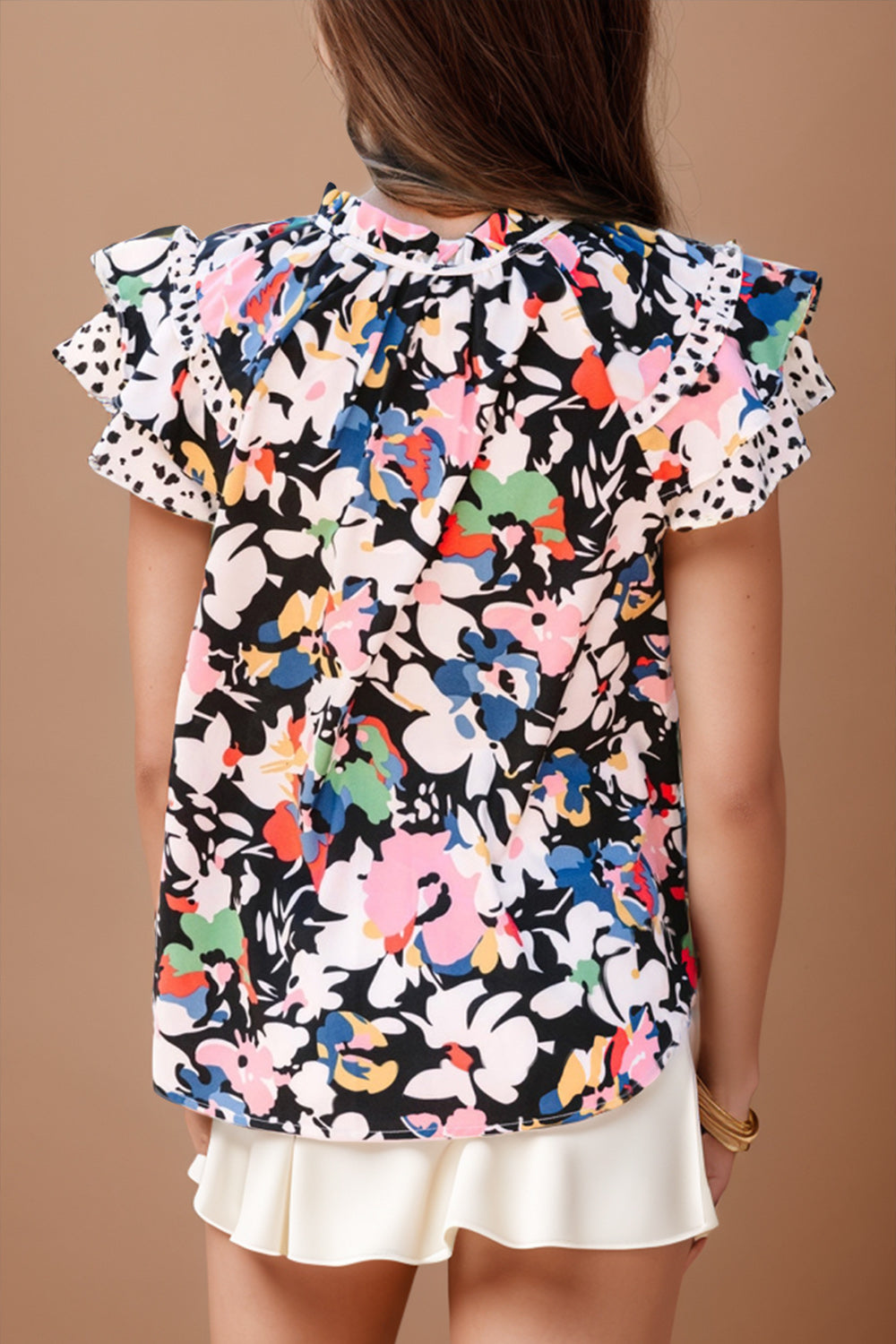 Dalmatian trim floral print blouse with ruffled sleeves and a high neckline.