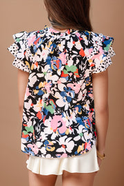 Dalmatian trim floral print blouse with ruffled sleeves and a high neckline.