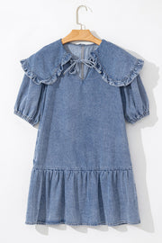 Denim mini dress with ruffle collar, tie neck, puff sleeves, and tiered ruffle hem.