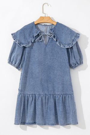 Denim mini dress with ruffle collar, tie neck, puff sleeves, and tiered ruffle hem.