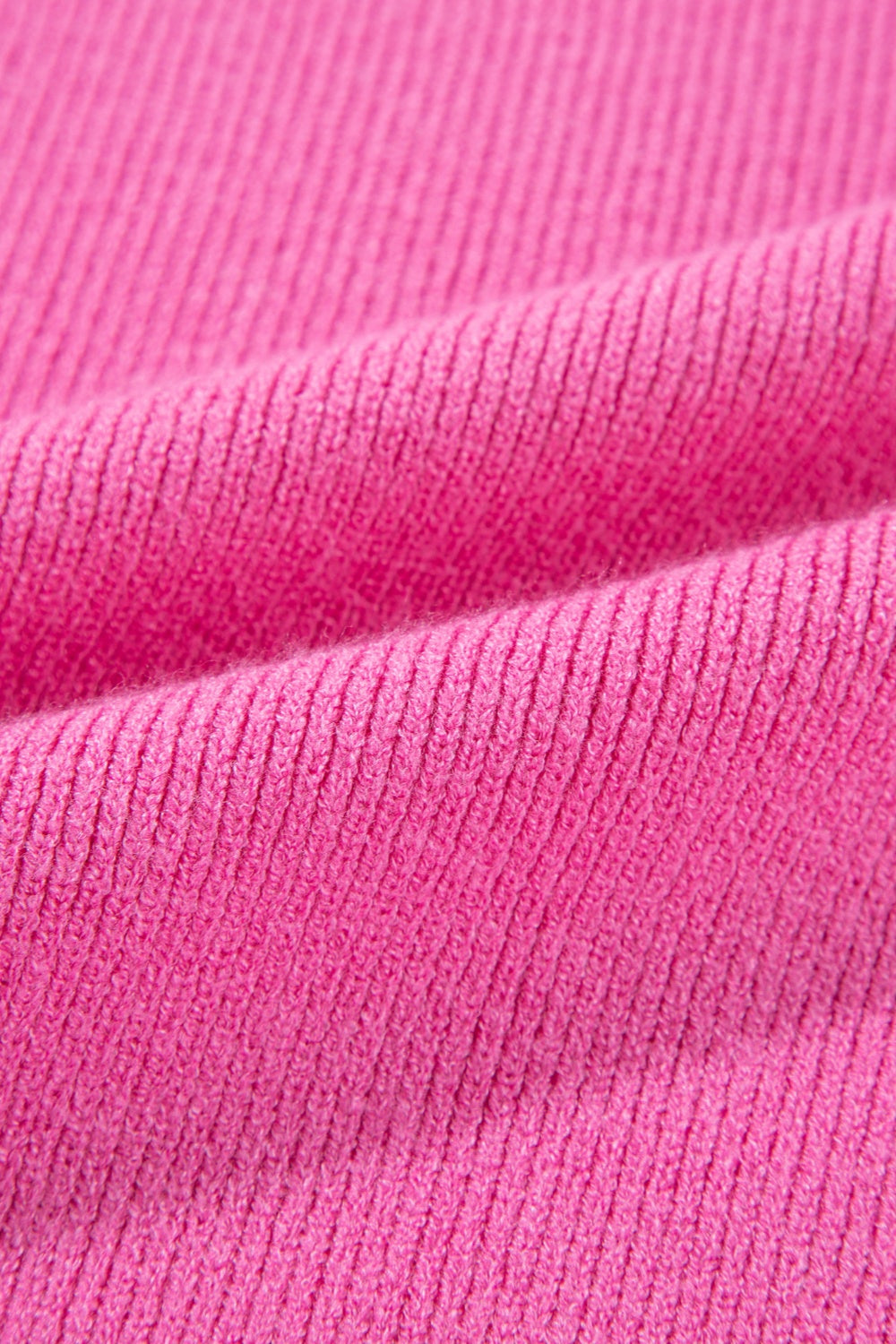Colorblock puff sleeve sweater in fuchsia pink knit fabric with ribbed texture.