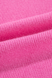 Colorblock puff sleeve sweater in fuchsia pink knit fabric with ribbed texture.