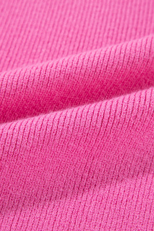 Colorblock puff sleeve sweater in fuchsia pink knit fabric with ribbed texture.