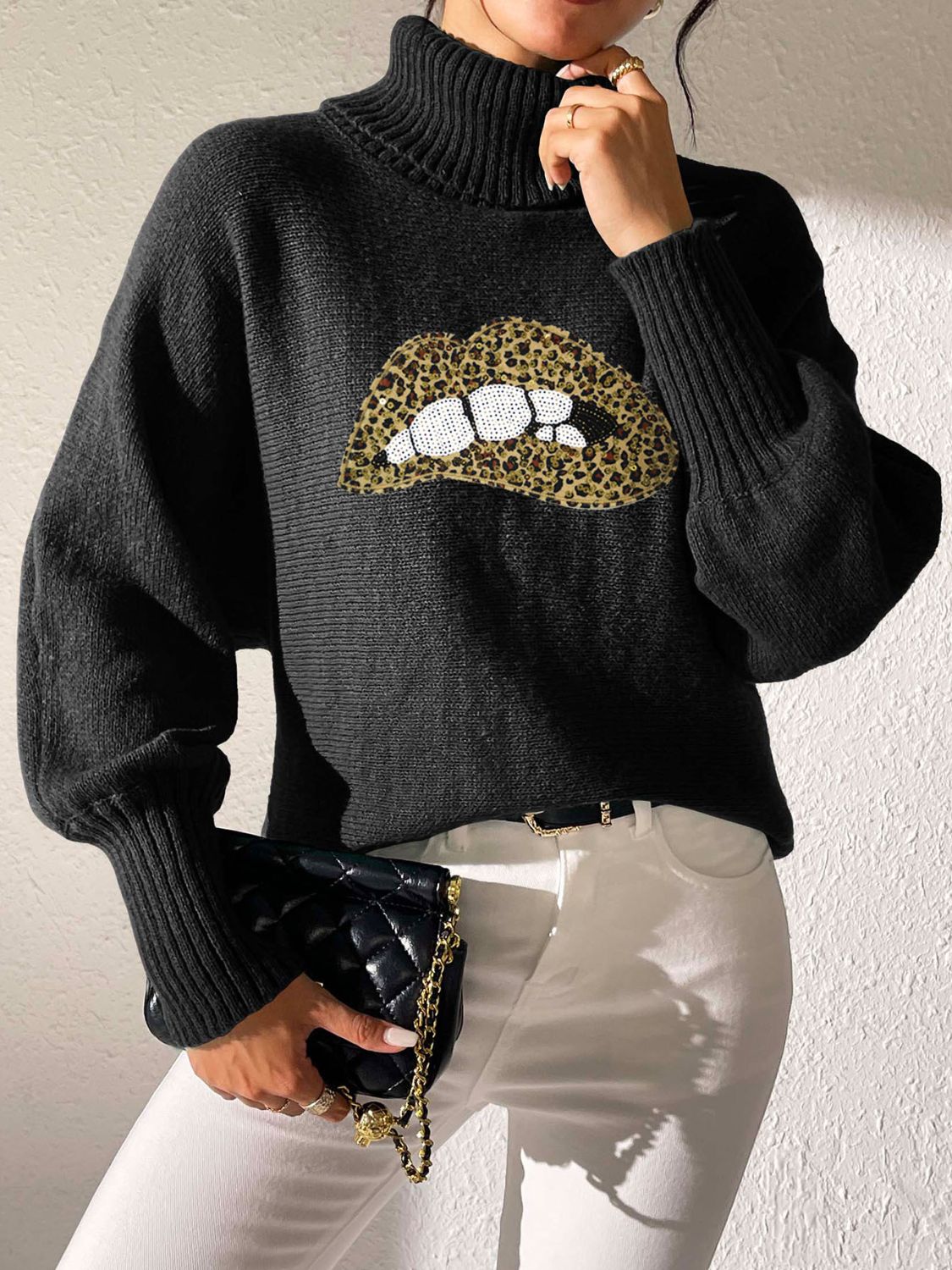 Black turtleneck sweater with sequin lip detail and balloon sleeves