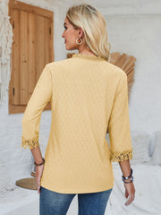 Light yellow eyelet blouse with lace trim at neckline and cuffs