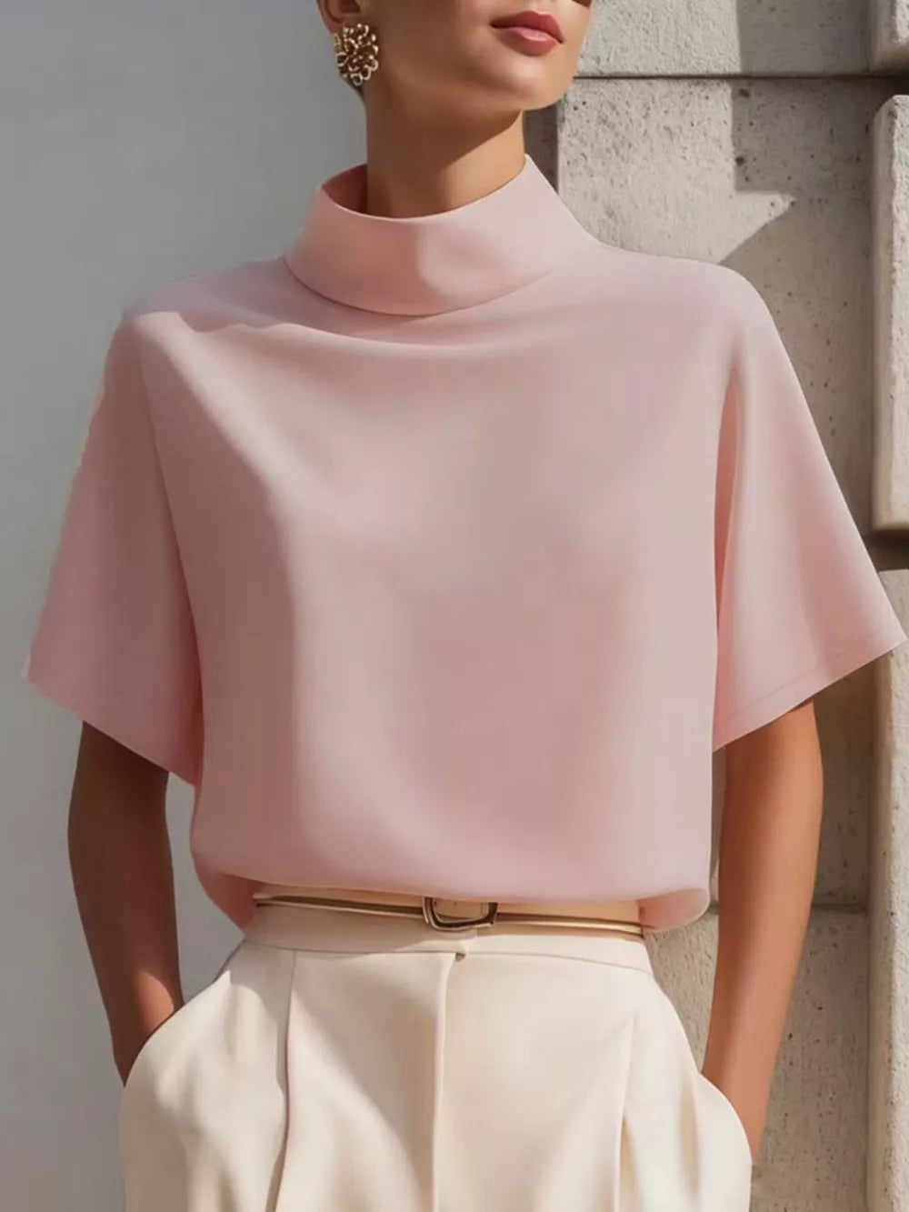 Blush pink polyester mock neck t-shirt with relaxed short sleeves.