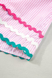 Blush pink and white striped blouse with scalloped trim in pink, white, and teal.