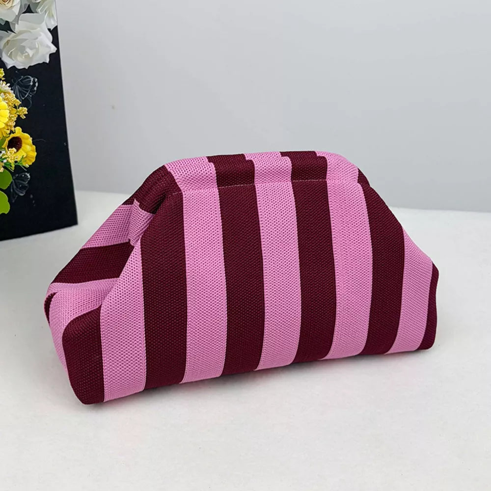 Vibrant knit clutch with striking pink and burgundy stripes.