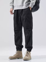 Black relaxed fit cargo sweatpants with elastic cuffs and side pockets.