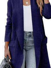 Dark blue open-front duster cardigan with pockets and a draped neckline, styled with jeans.