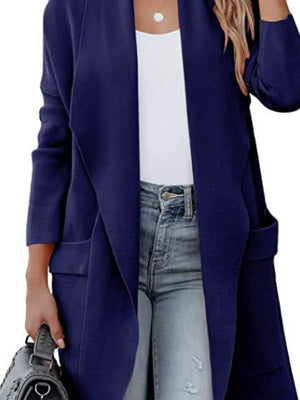 Dark blue open-front duster cardigan with pockets and a draped neckline, styled with jeans.