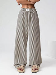 Navy striped high-waisted wide-leg pants with drawstring detail.