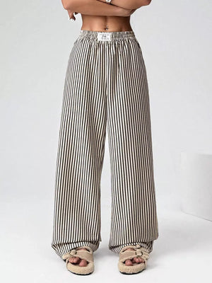 Navy striped high-waisted wide-leg pants with drawstring detail.