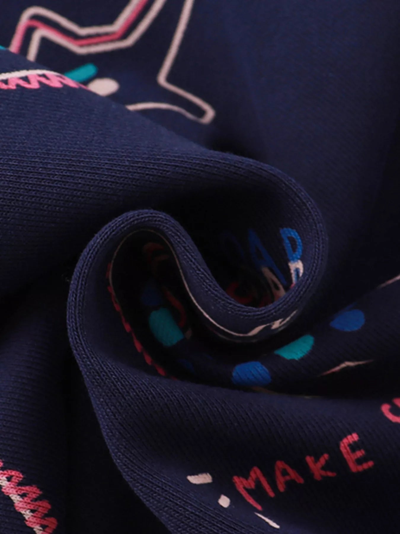 Dark navy cotton sweatshirt with dinosaur print and ruffled detail.