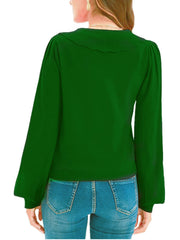 Green knit cardigan with scalloped collar and balloon sleeves.