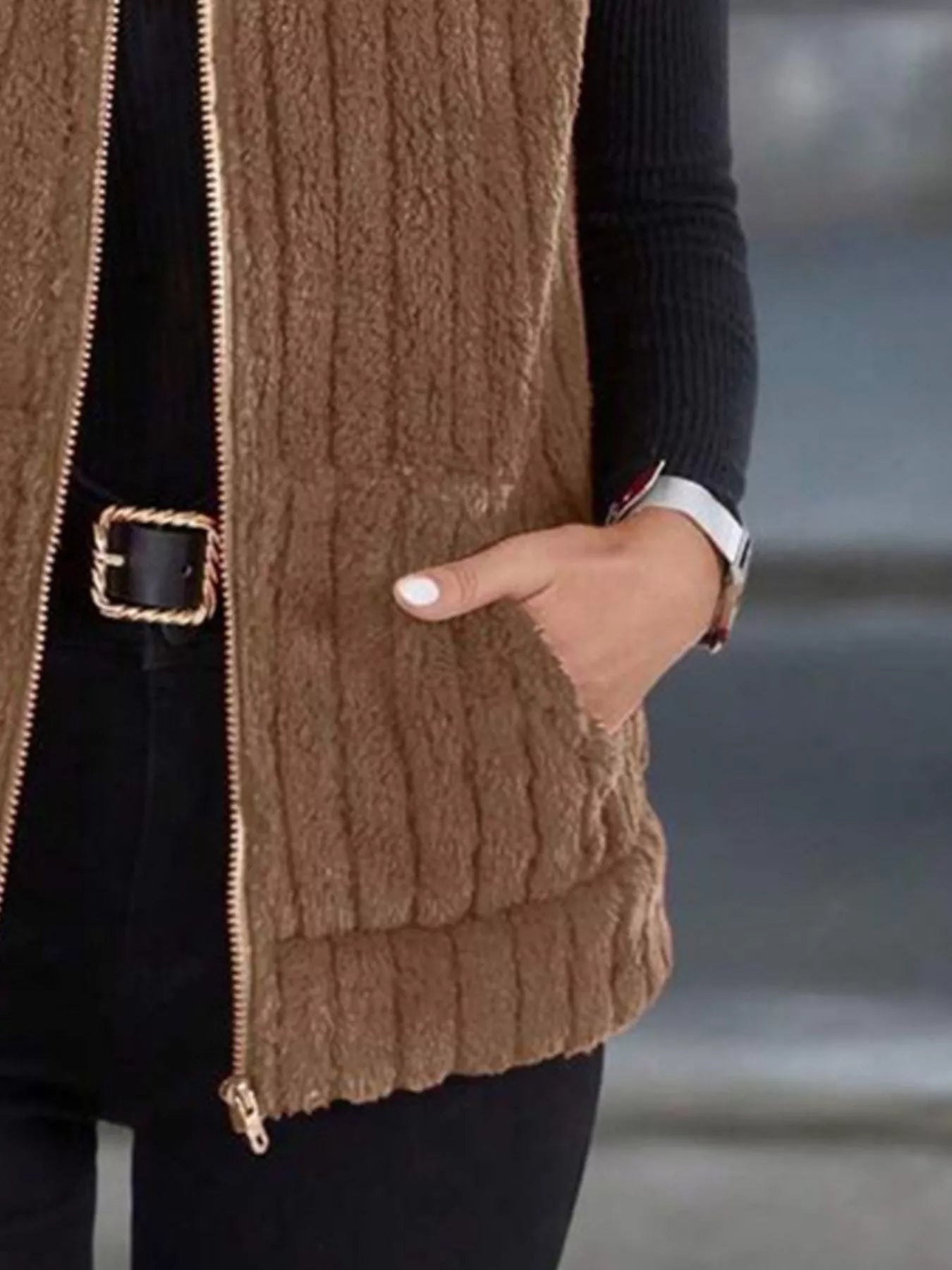 Brown fleece zip-up vest with pockets and ribbed texture.