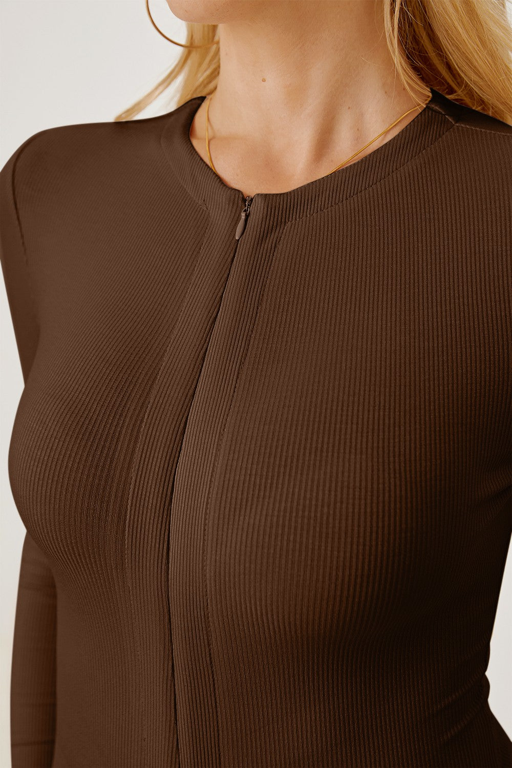 Brown ribbed bodysuit with long sleeves and a zip-front plunge neckline.