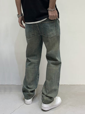 Men's loose-fit jeans in blue-green wash with distressed detailing.