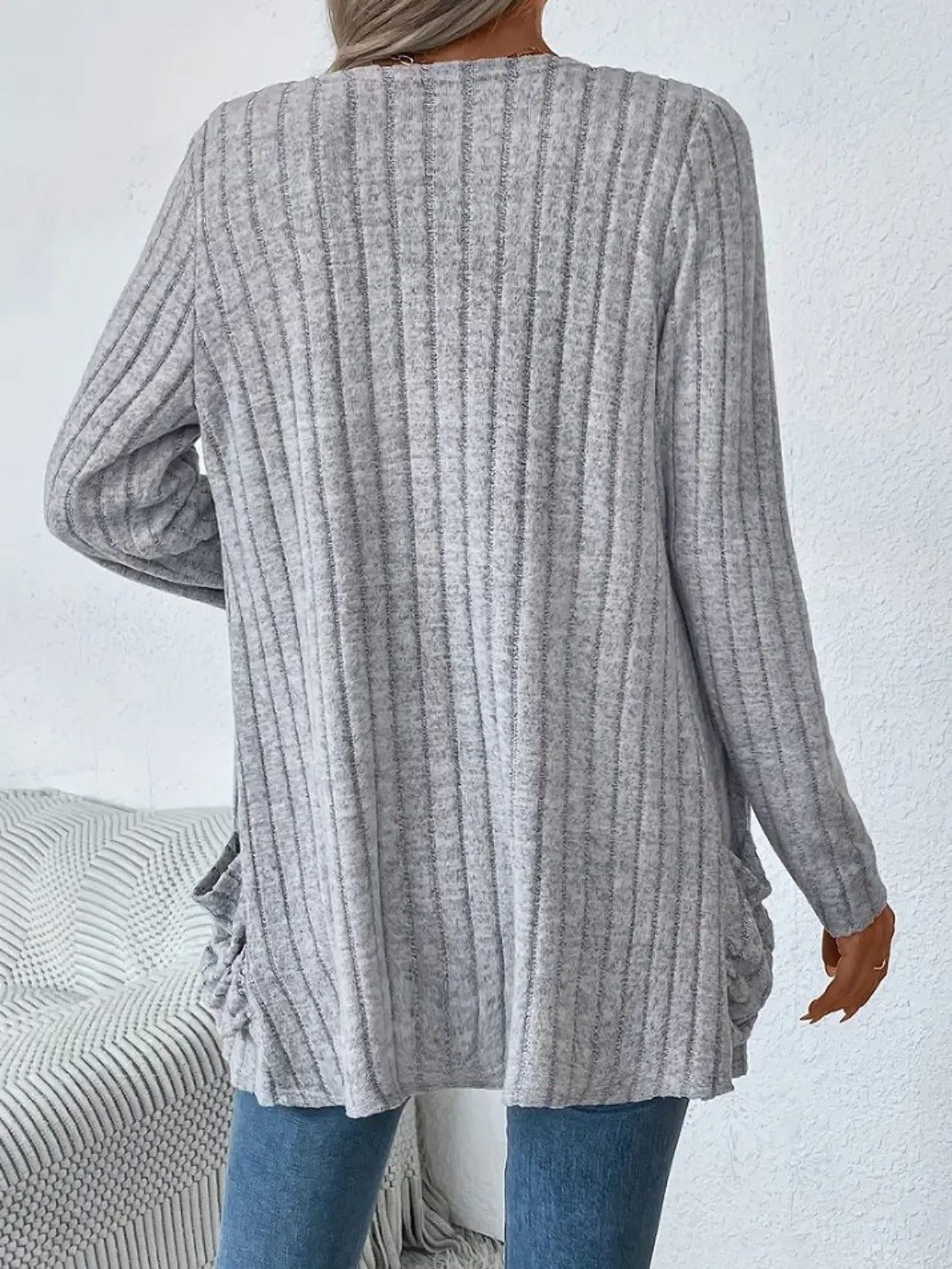 Light gray ribbed knit cardigan with long sleeves and ruched side details.