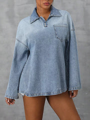Collared denim top with quarter zip and chest pocket in light blue wash.