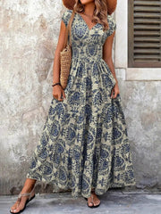 Blue flower damask print maxi dress with cap sleeves and tiered skirt.