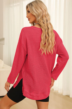 Waffle knit oversized top in strawberry with side slits and long sleeves.