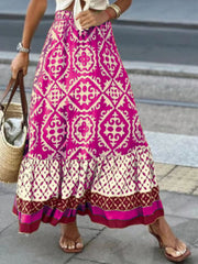Tiered maxi skirt in hot pink with medallion print, ruffled hem, and bohemian style.