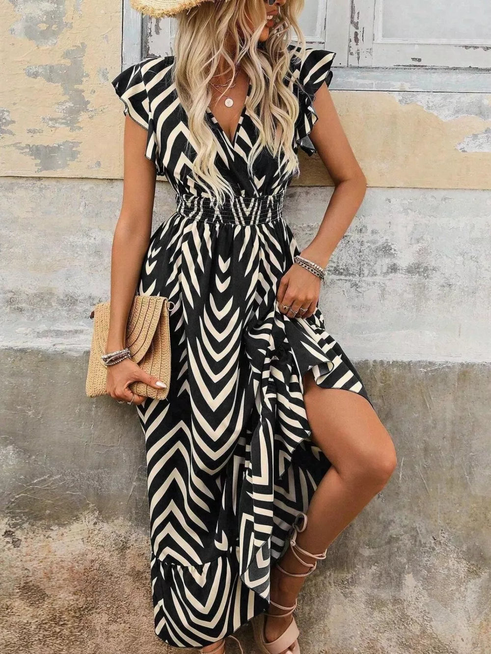 Black geometric ruffled midi dress with V-neck, smocked waist, and thigh slit.