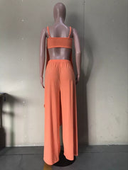 Orange cami and wide-leg pants set with asymmetrical draped hem detail.