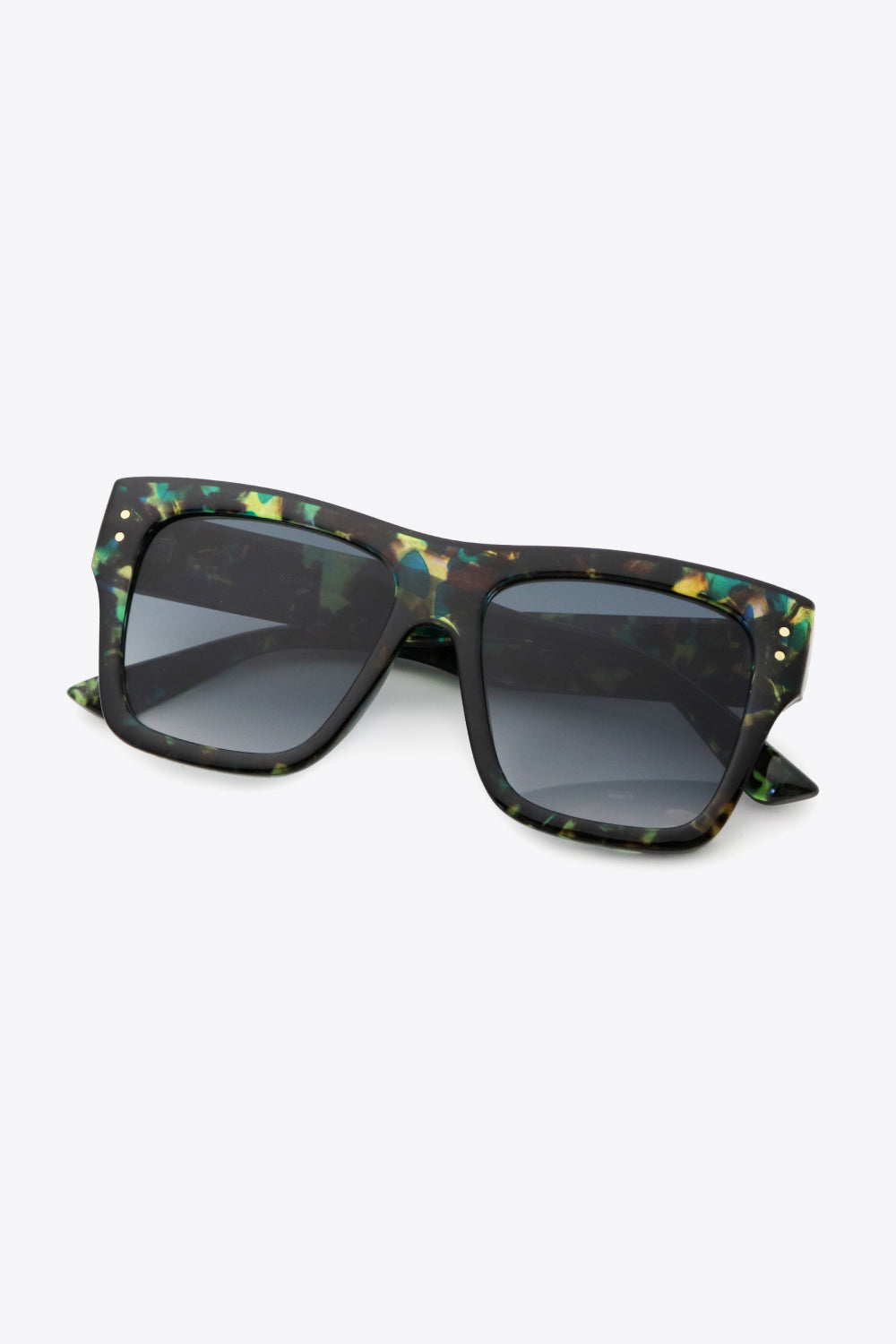 Prismatic square frame sunglasses with dark lenses and gold stud details.