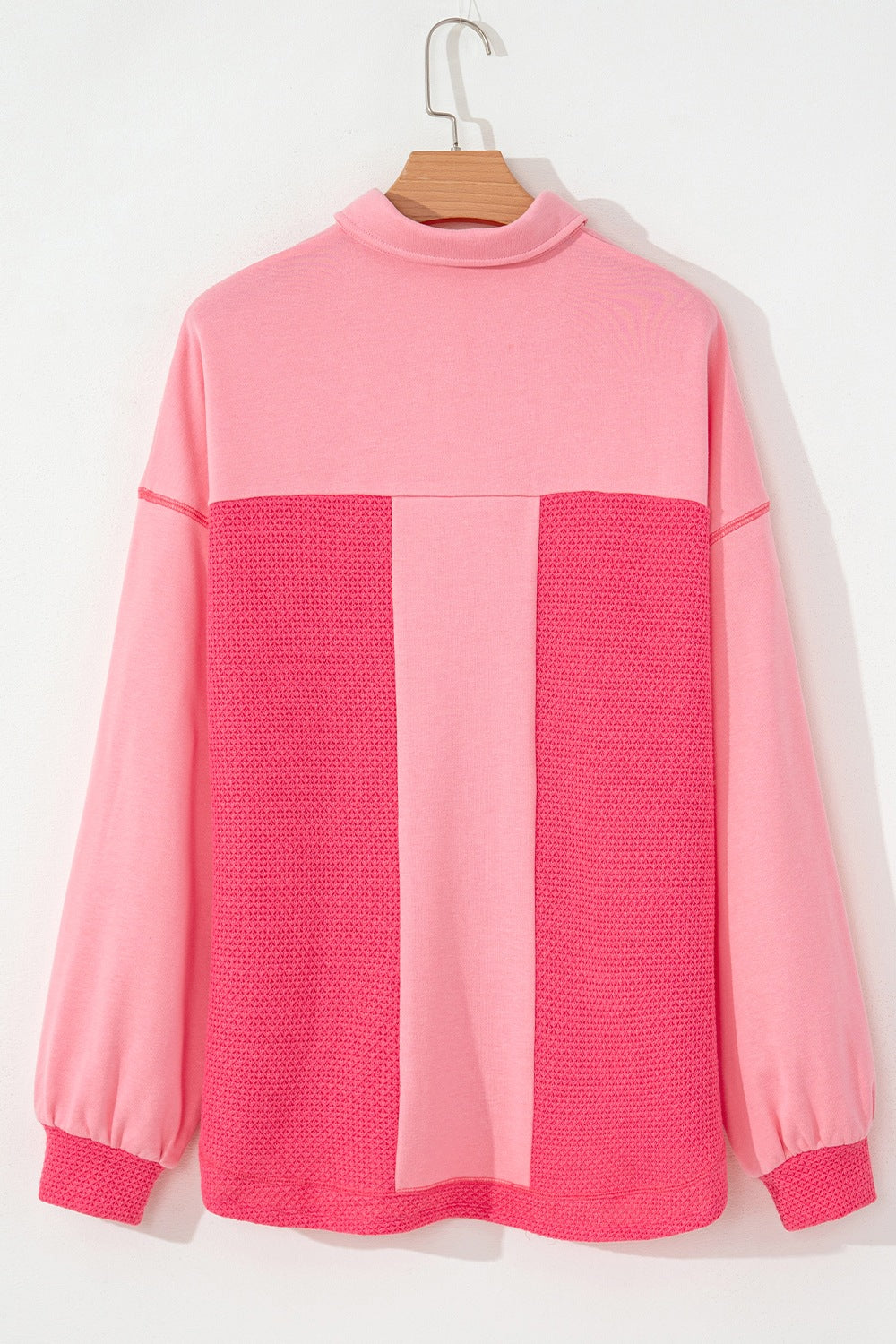 Blush pink shacket with waffle knit panels and a mock neck.