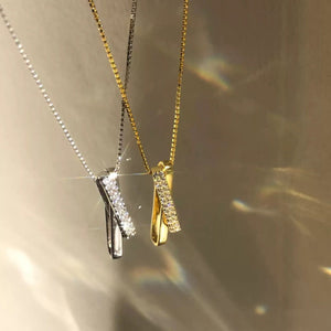 Sterling silver and gold necklaces with crossover zircon pendants on box chains