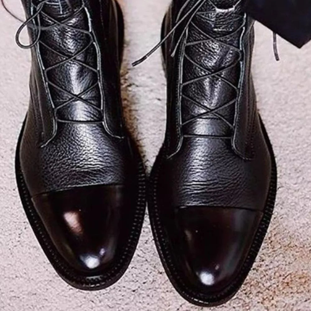Black leather ankle boots with glossy cap toe and lace-up front