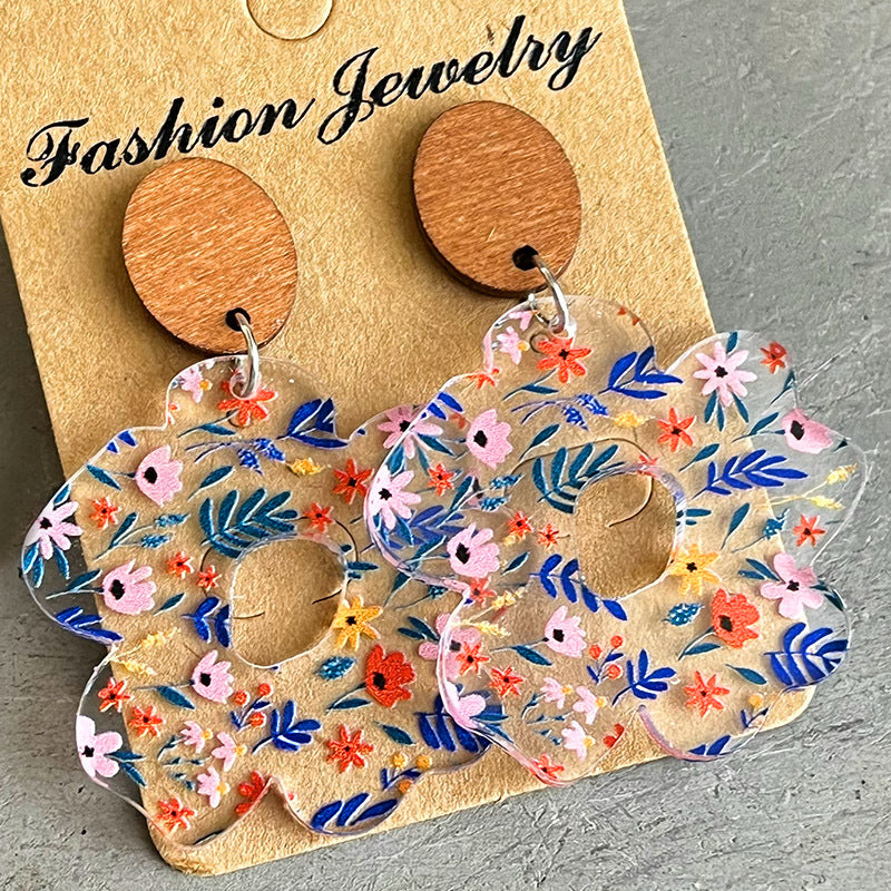Floral acrylic bloom earrings with wood tops, featuring a colorful floral pattern.