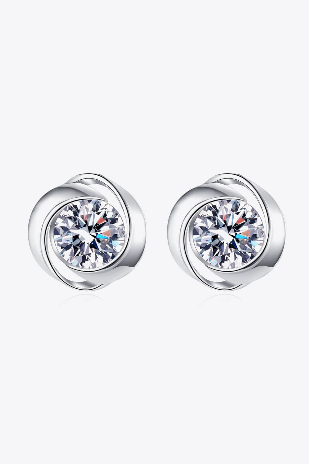 Silver halo crystal stud earrings with a swirling design