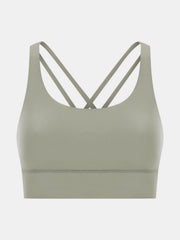 Sage green performance bra with crisscross straps and a wide band.