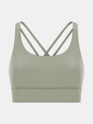Sage green performance bra with crisscross straps and a wide band.