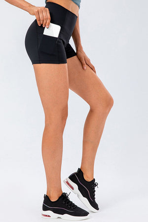 Black performance shorts with side pockets, a phone visible in one pocket.